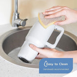 Stainless steel tumbler with ergonomic handle and matte finish.